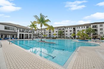 A large swimming pool with buildings in the background